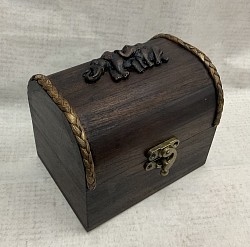 Item #  TB-19 R   Small wooden  round top hinged chest is @ 9cm x 12cm in size.. It comes with a nice metal latch on the front. The resin design as well as the color and texture of the box can vary some.