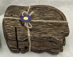 Item # CPE-2   Elephant Palmwood coaster set ( 4 pieces)  wrapped with string. - Color and texture of the wood can vary.