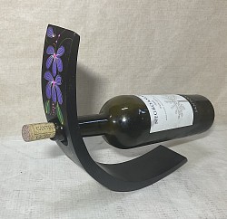 Item #  MBH-P F  ( Flower) Mango wood wine bottle holder- This sample has dark brown paint base and a hand painted flower design. These can be ordered in different colors and designs